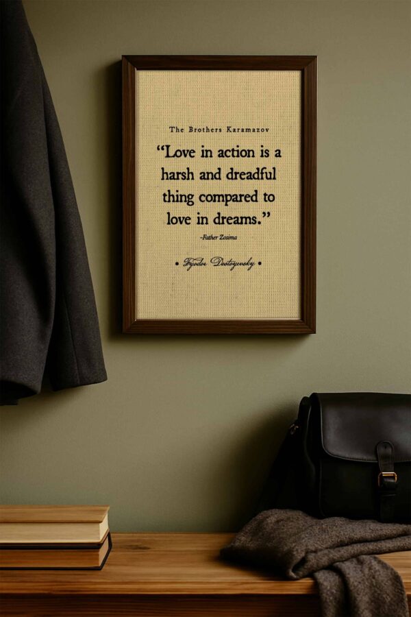 Minimalist entryway scene featuring the Dostoyevsky quote on a green wall above a bench with a wool coat, black satchel, and folded scarf below.