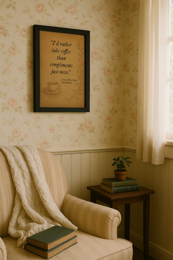 Black frame canvas mounted on floral wallpaper above a cozy reading chair draped in a knit blanket near a sunlit window.