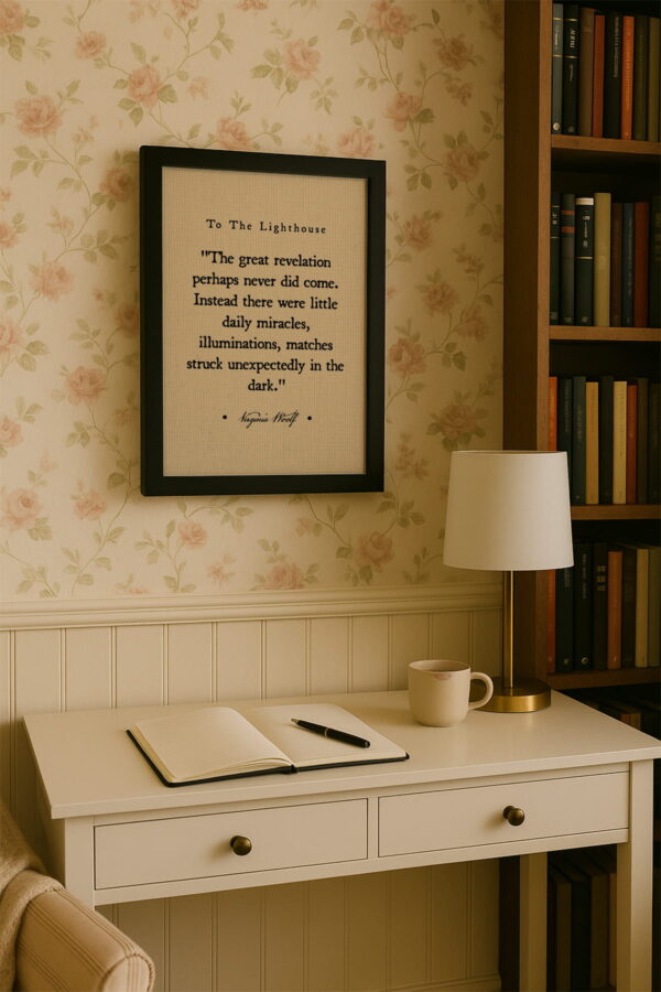 Black frame canvas above a cream writing desk with a journal, pen, and mug in a bright home library corner.