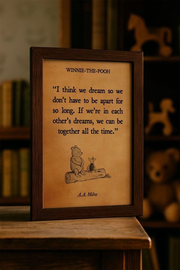 Framed Winnie-the-Pooh quote canvas featuring the phrase “If we’re in each other’s dreams, we can be together all the time,” displayed on a wooden table in a cozy room with toys and books in the background.