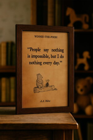 Framed canvas of a Winnie-the-Pooh quote sits on a wooden table with a softly blurred bookshelf in the background, evoking a cozy, nostalgic atmosphere.