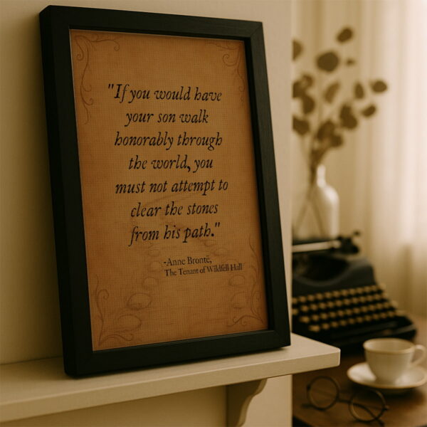 Black frame canvas leaning on a cream-colored shelf beside a typewriter and coffee cup in a softly lit writing nook.