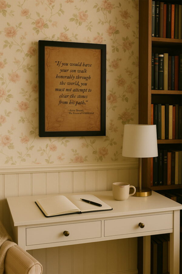 Black frame canvas above a cream writing desk with a journal, pen, and mug in a bright home library corner.